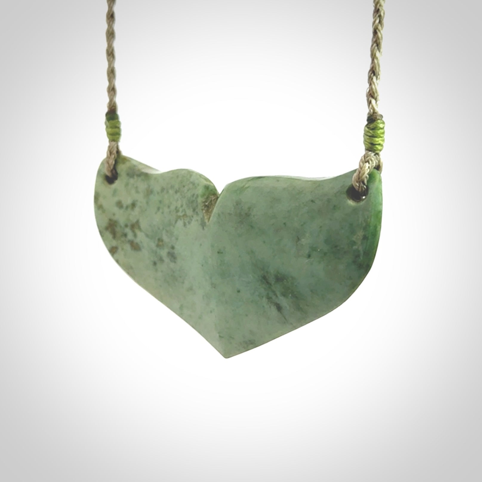 Hand carved New Zealand Jade whale tail pendant.