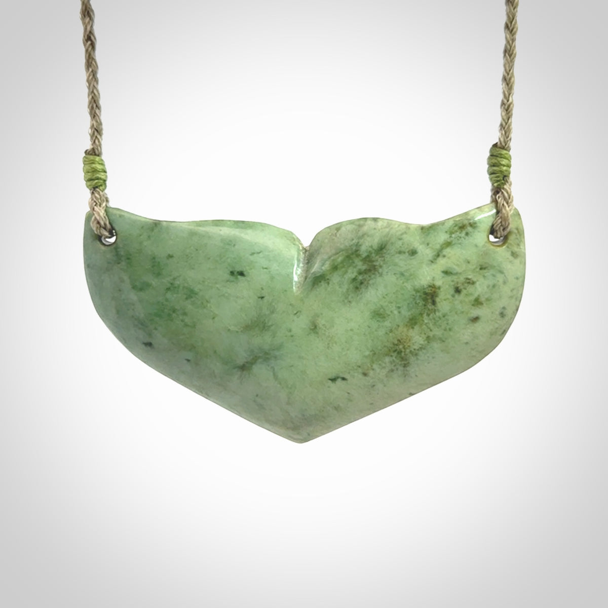 Hand carved New Zealand Jade whale tail pendant.