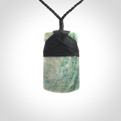 This is a handcrafted aotea stone Toki pendant.