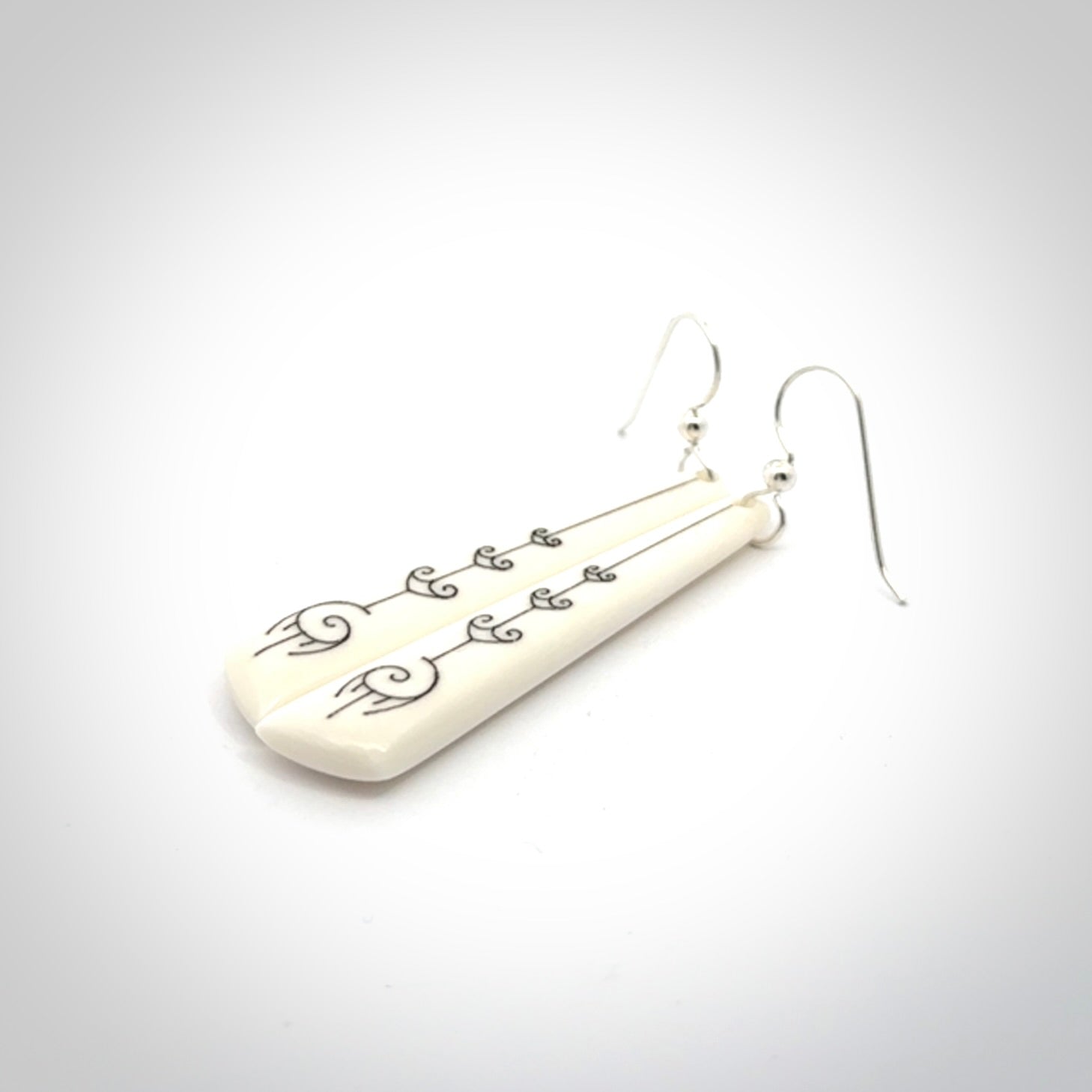 Hand carved large bone earrings with dreamcatcher engraving.