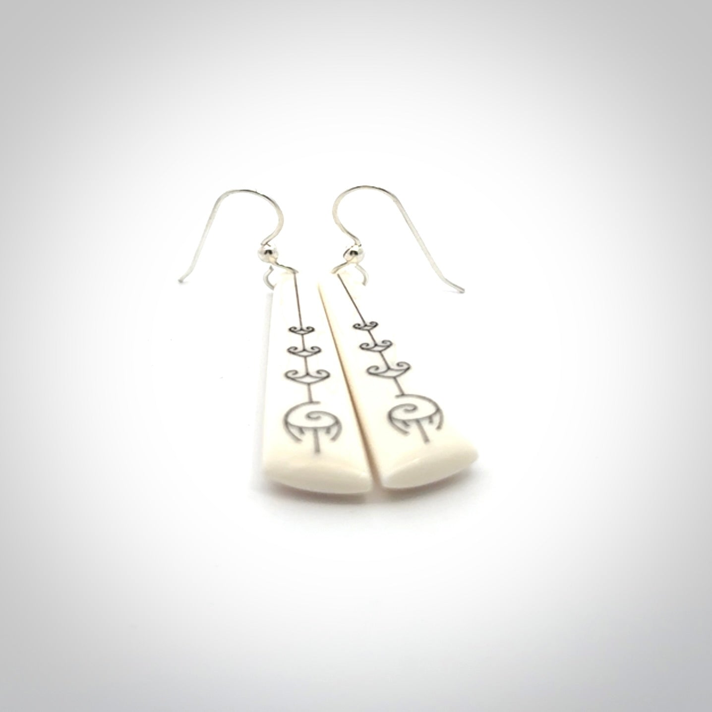 Hand carved large bone earrings with dreamcatcher engraving.