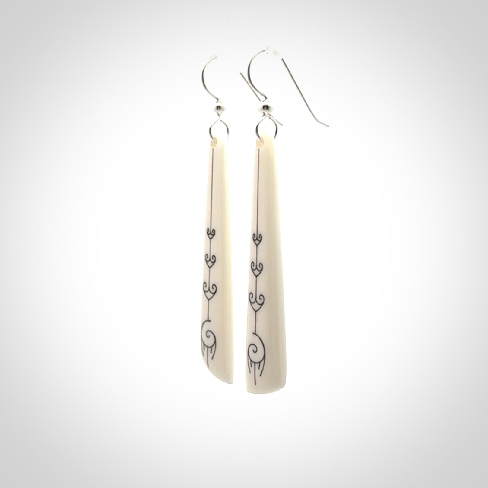 Hand carved large bone earrings with dreamcatcher engraving.