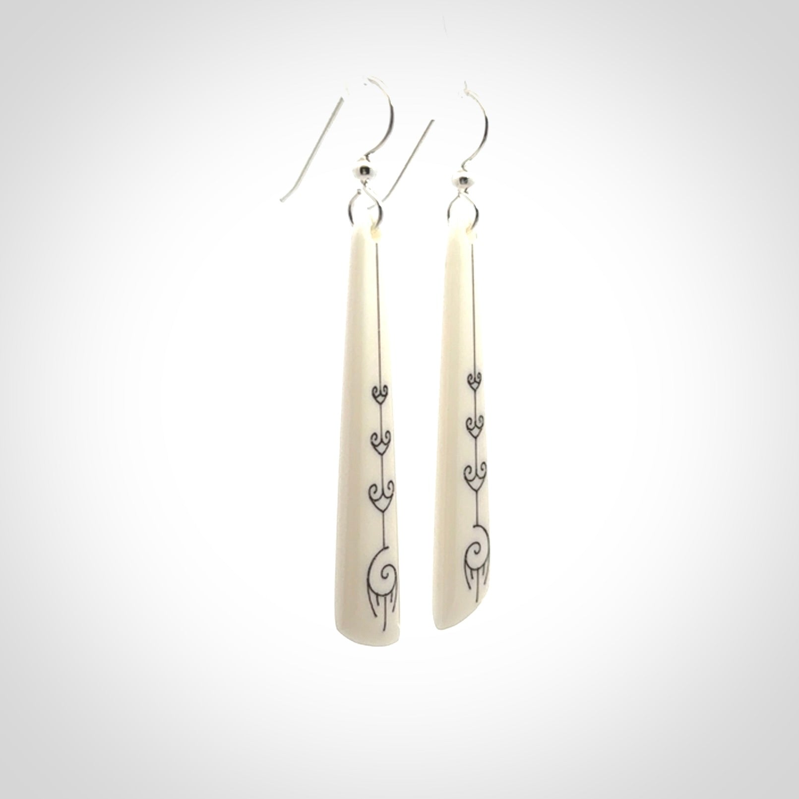 Hand carved large bone earrings with dreamcatcher engraving.