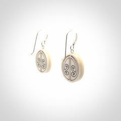 Hand carved round bone koru earrings with double sided engraving.