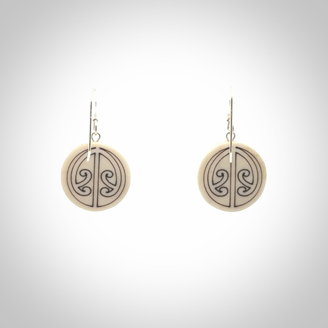 Hand carved round bone koru earrings with double sided engraving.