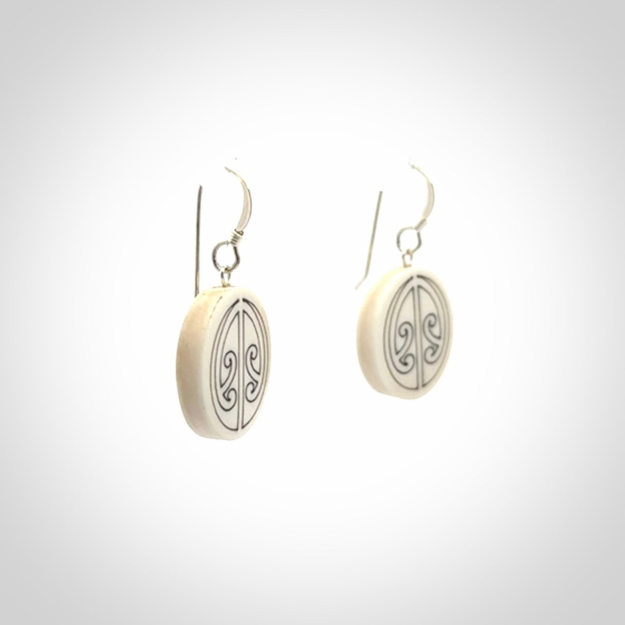 Hand carved round bone koru earrings with double sided engraving.