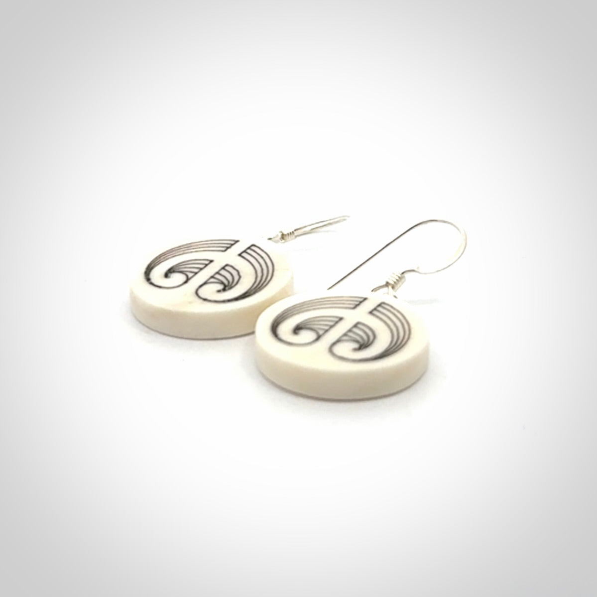 Hand carved round bone koru earrings with double sided engraving.