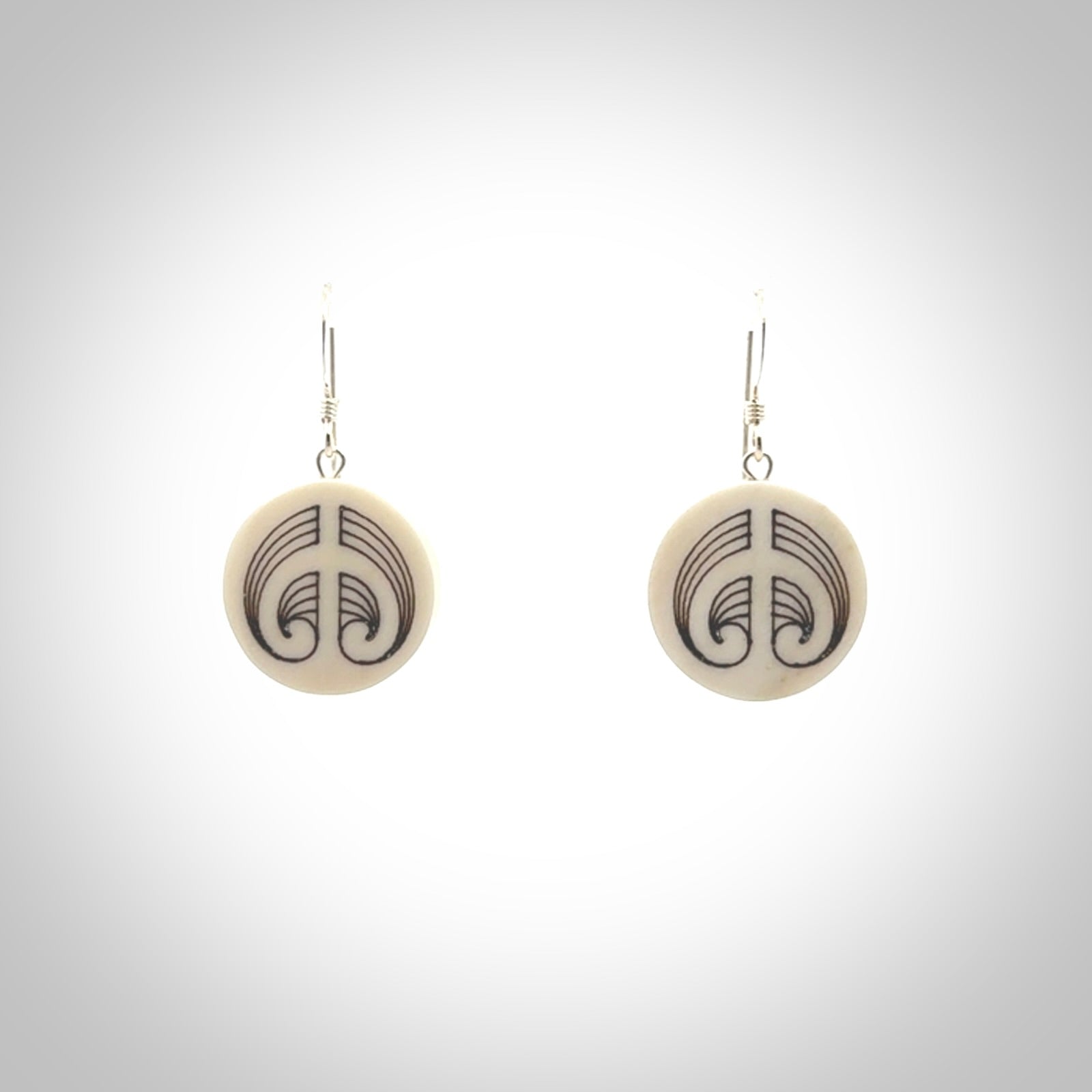 Hand carved round bone koru earrings with double sided engraving.