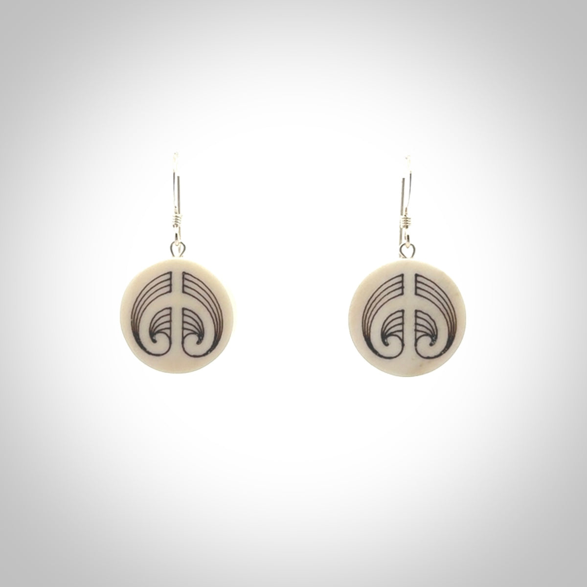 Hand carved round bone koru earrings with double sided engraving.