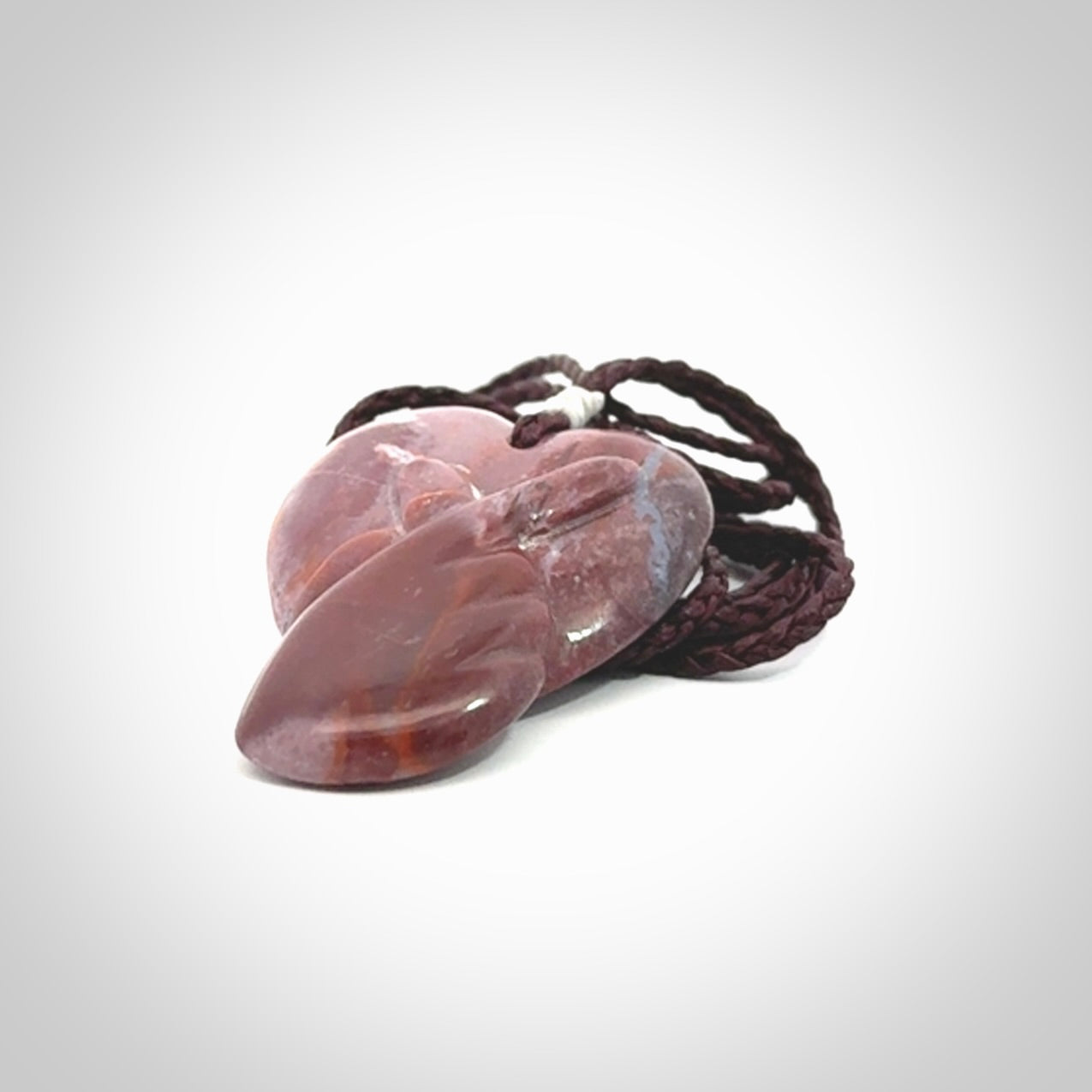 This is a hand carved love heart pendant made from a gorgeous and striking piece of Brecciated jasper stone. This is a superbly carved and very unique piece. For sale online from NZ Pacific.