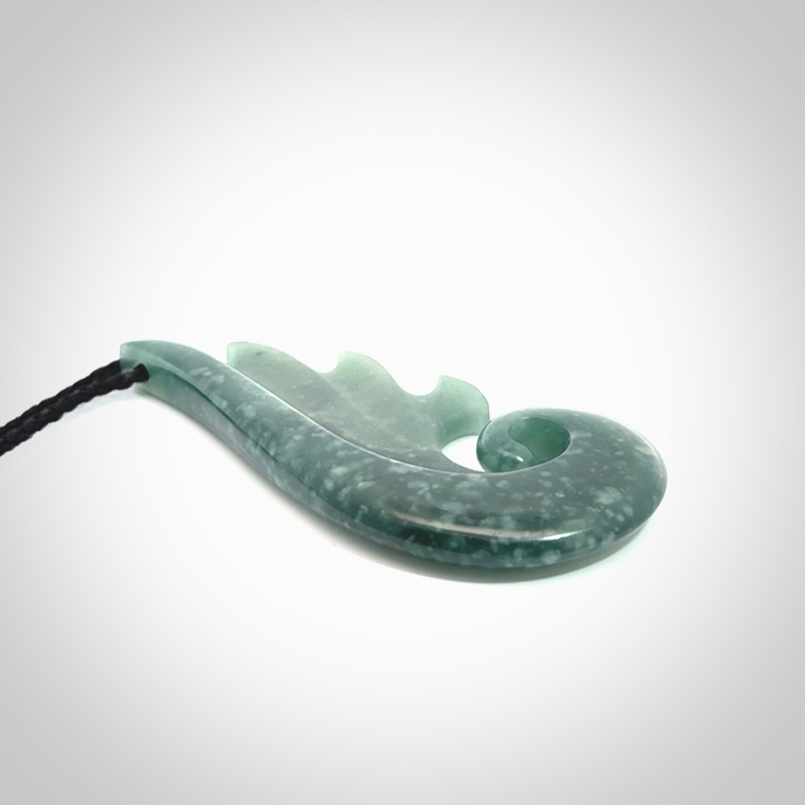 Hand carved large Guatemalan Jade shell koru drop pendant.