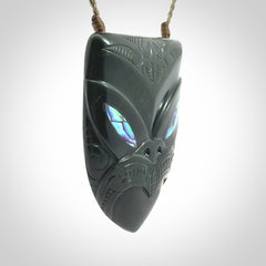This is a hand carved New Zealand Jade wheku pendant. It is made from New Zealand Jade and Paua shell.