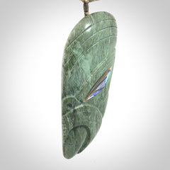 This is a hand carved New Zealand Jade wheku pendant. It is made from New Zealand Jade and Paua shell.