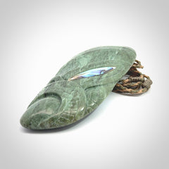 This is a hand carved New Zealand Jade wheku pendant. It is made from New Zealand Jade and Paua shell.