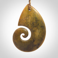 A hand carved koru pendant from New Zealand Flower Jade. The cord is a camel/marrakesh colour and is an adjustable length. A large hand made Koru necklace by New Zealand artist Kerry Thompson.