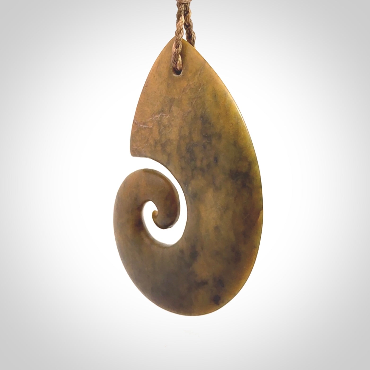 A hand carved koru pendant from New Zealand Flower Jade. The cord is a camel/marrakesh colour and is an adjustable length. A large hand made Koru necklace by New Zealand artist Kerry Thompson.