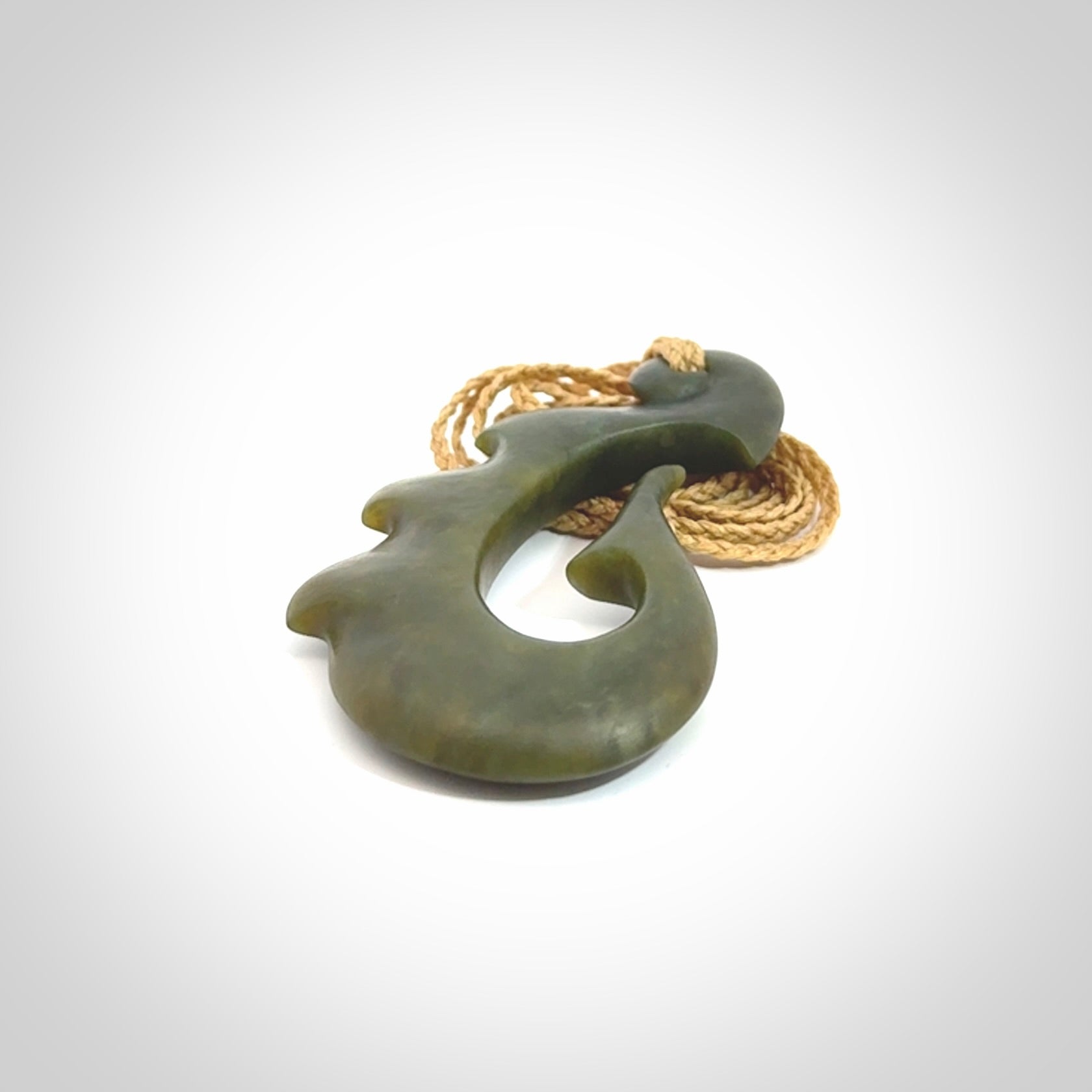 Hand carved New Zealand Totoweka Jade hook pendant.
