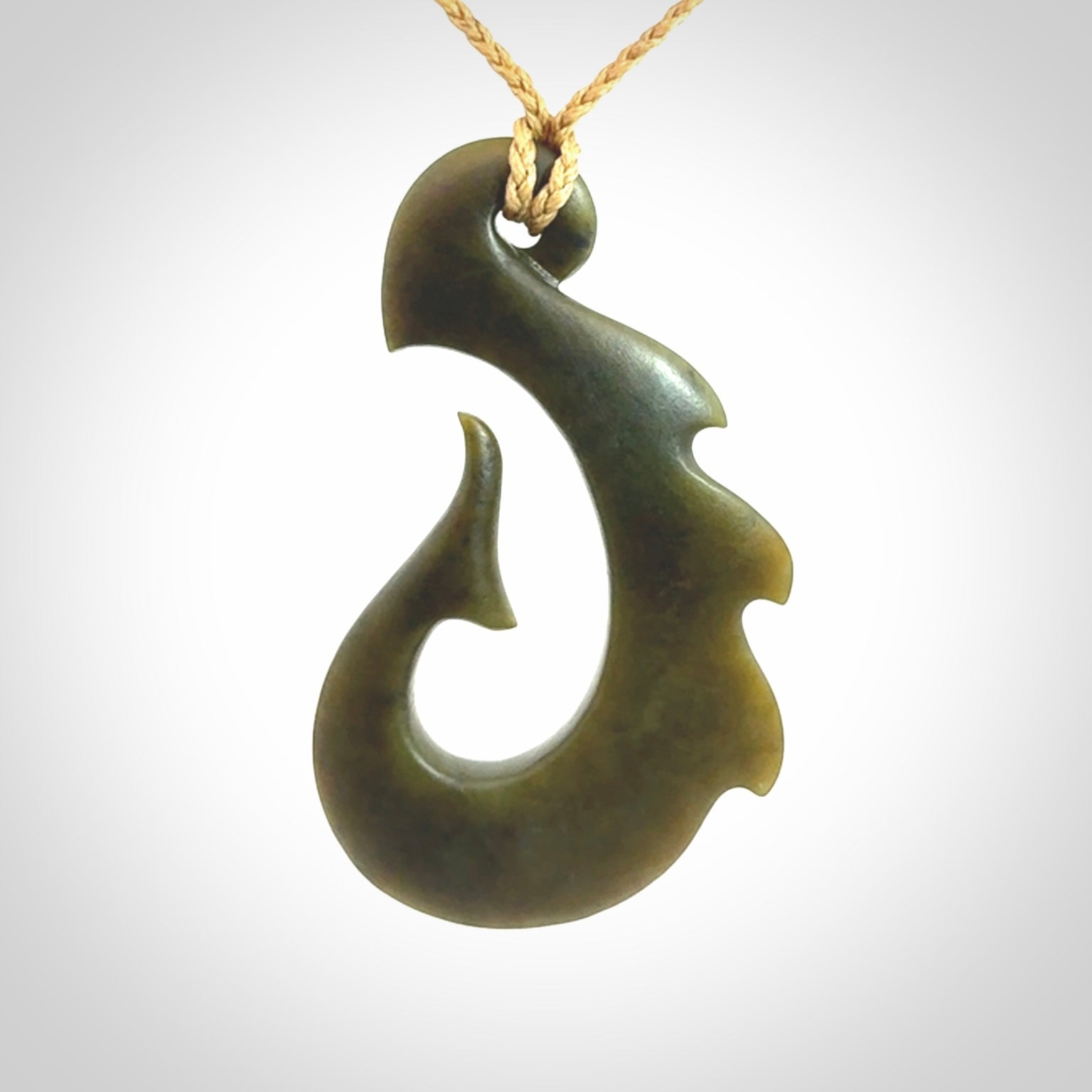 Hand carved New Zealand Totoweka Jade hook pendant.