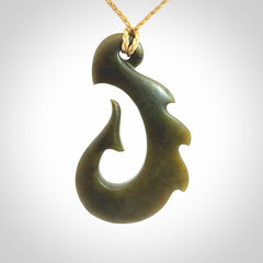 Hand carved New Zealand Totoweka Jade hook pendant.