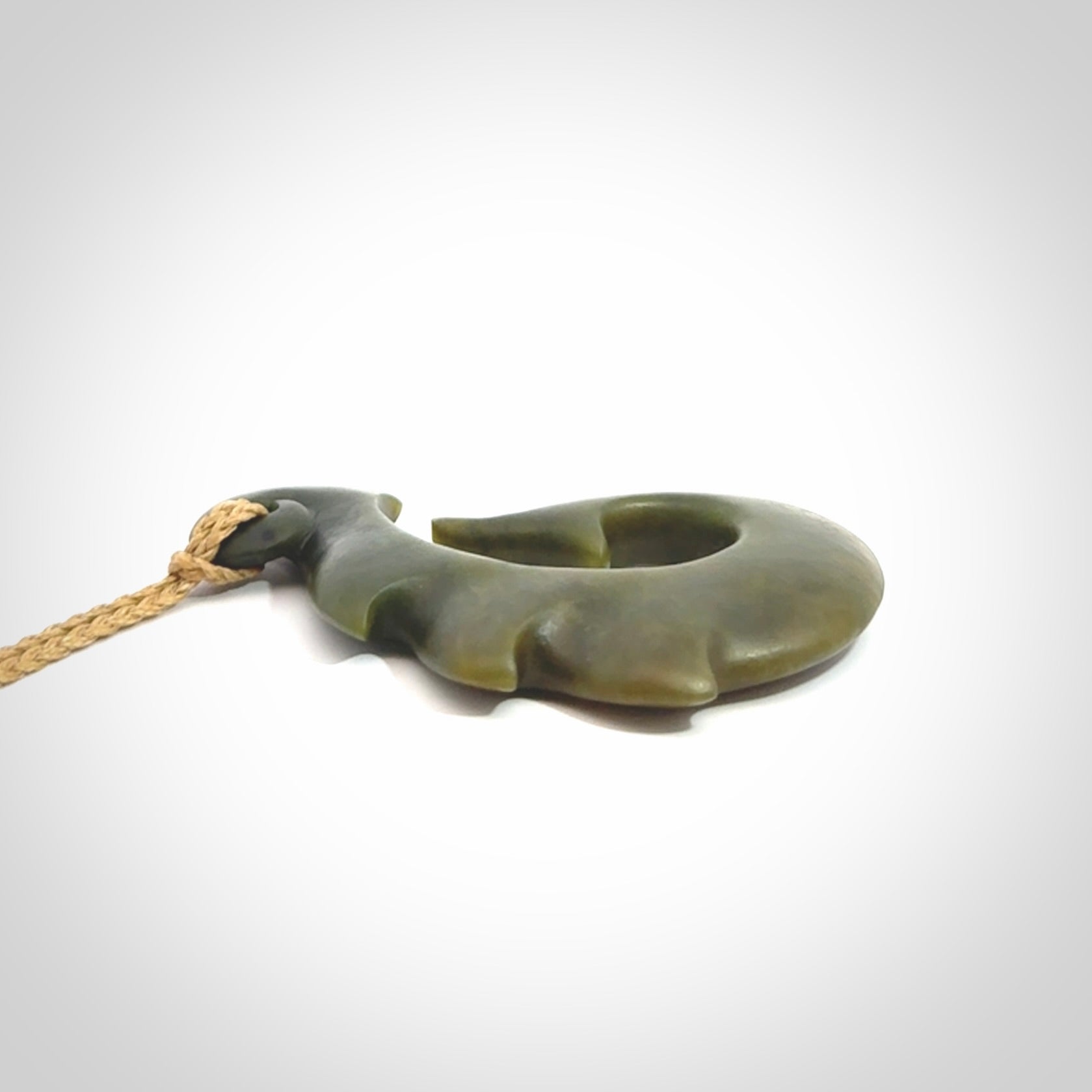 Hand carved New Zealand Totoweka Jade hook pendant.