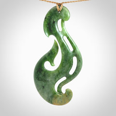 A hand carved large New Zealand Jade Hook, Matau, necklace. The cord is adjustable.