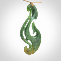 A hand carved large New Zealand Jade Hook, Matau, necklace. The cord is adjustable.