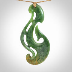 A hand carved large New Zealand Jade Hook, Matau, necklace. The cord is adjustable.