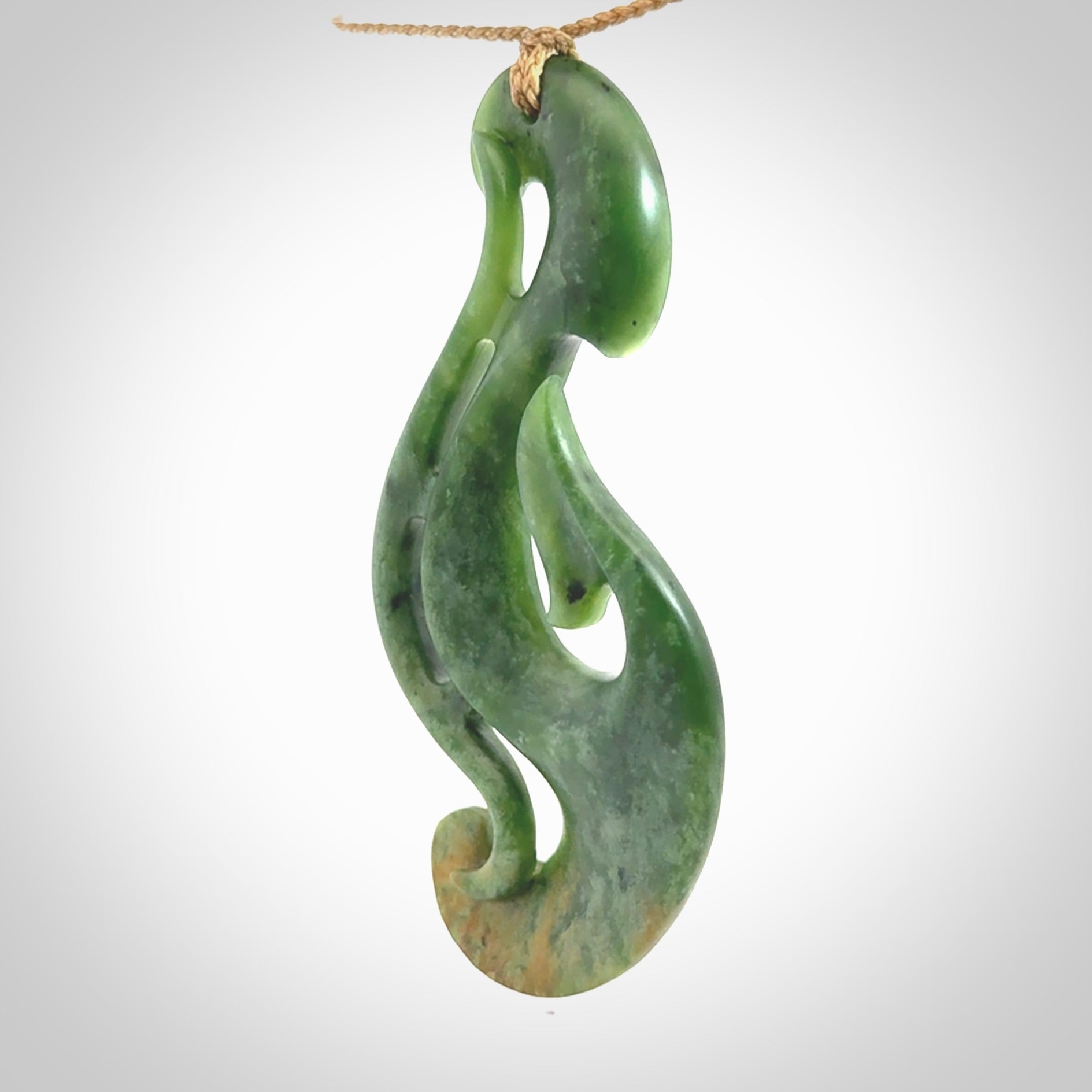 A hand carved large New Zealand Jade Hook, Matau, necklace. The cord is adjustable.