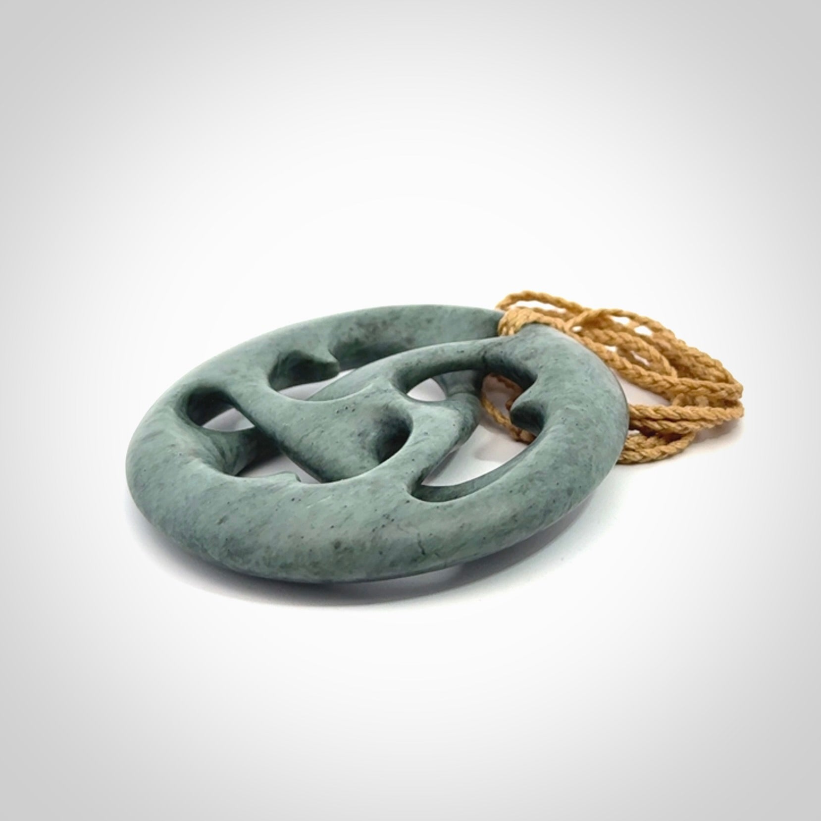 Hand carved New Zealand Nelson blue jade, complex twist drop pendant. Hand made complex twist pendant hand carved in New Zealand.