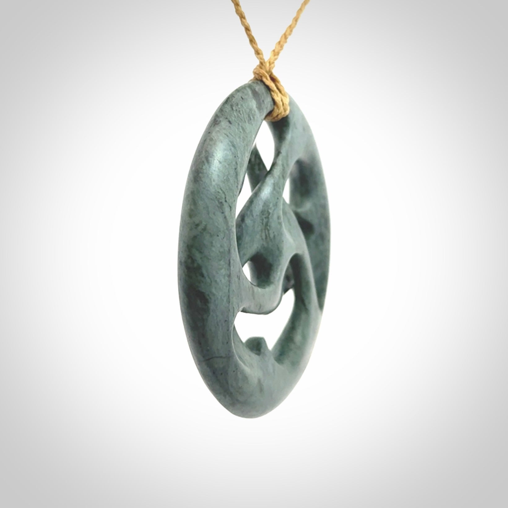 Hand carved New Zealand Nelson blue jade, complex twist drop pendant. Hand made complex twist pendant hand carved in New Zealand.