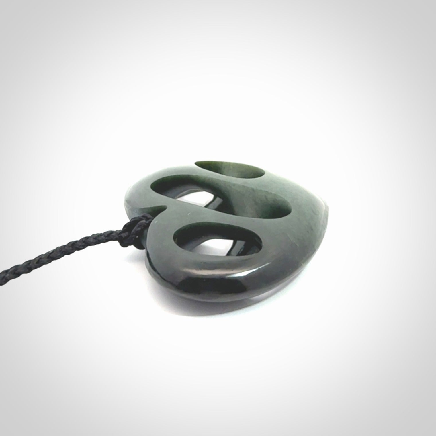 Hand carved New Zealand jade, complex twist heart pendant.