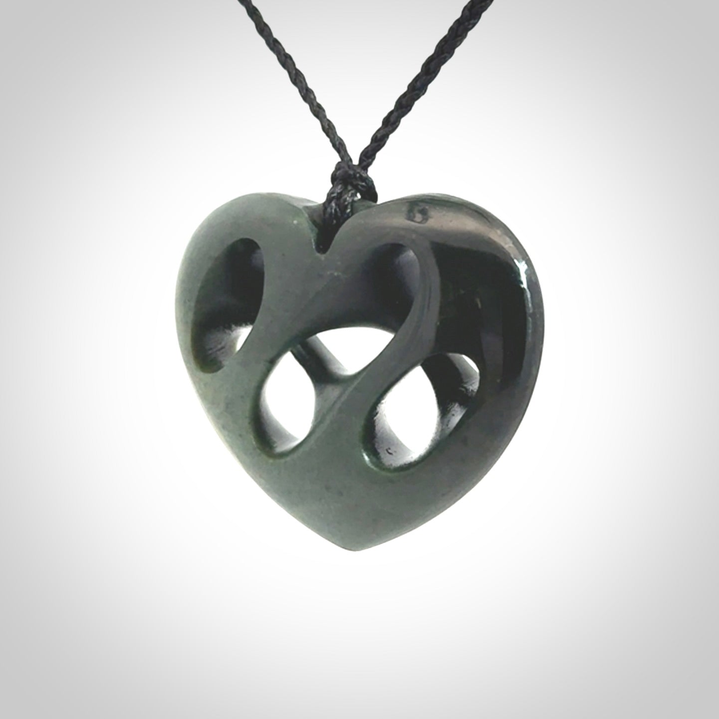 Hand carved New Zealand jade, complex twist heart pendant.