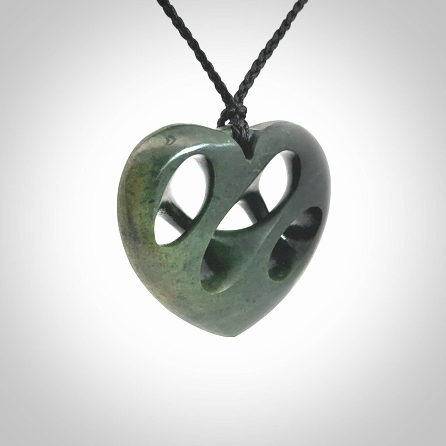 Hand carved New Zealand jade, complex twist heart pendant.