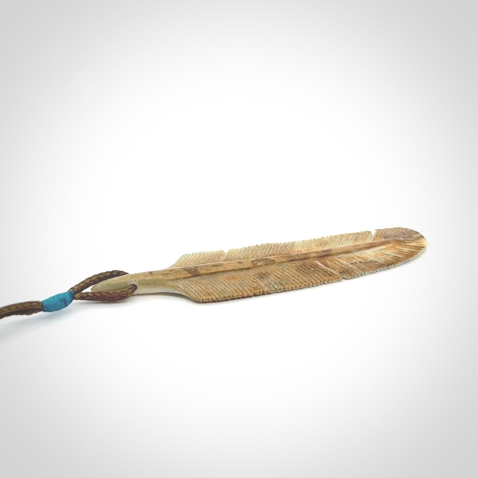 This photo shows a finely carved feather pendant for all you bird lovers and aficionados of the art of flight. It is hand carved by us from rare woolly mammoth tusk.