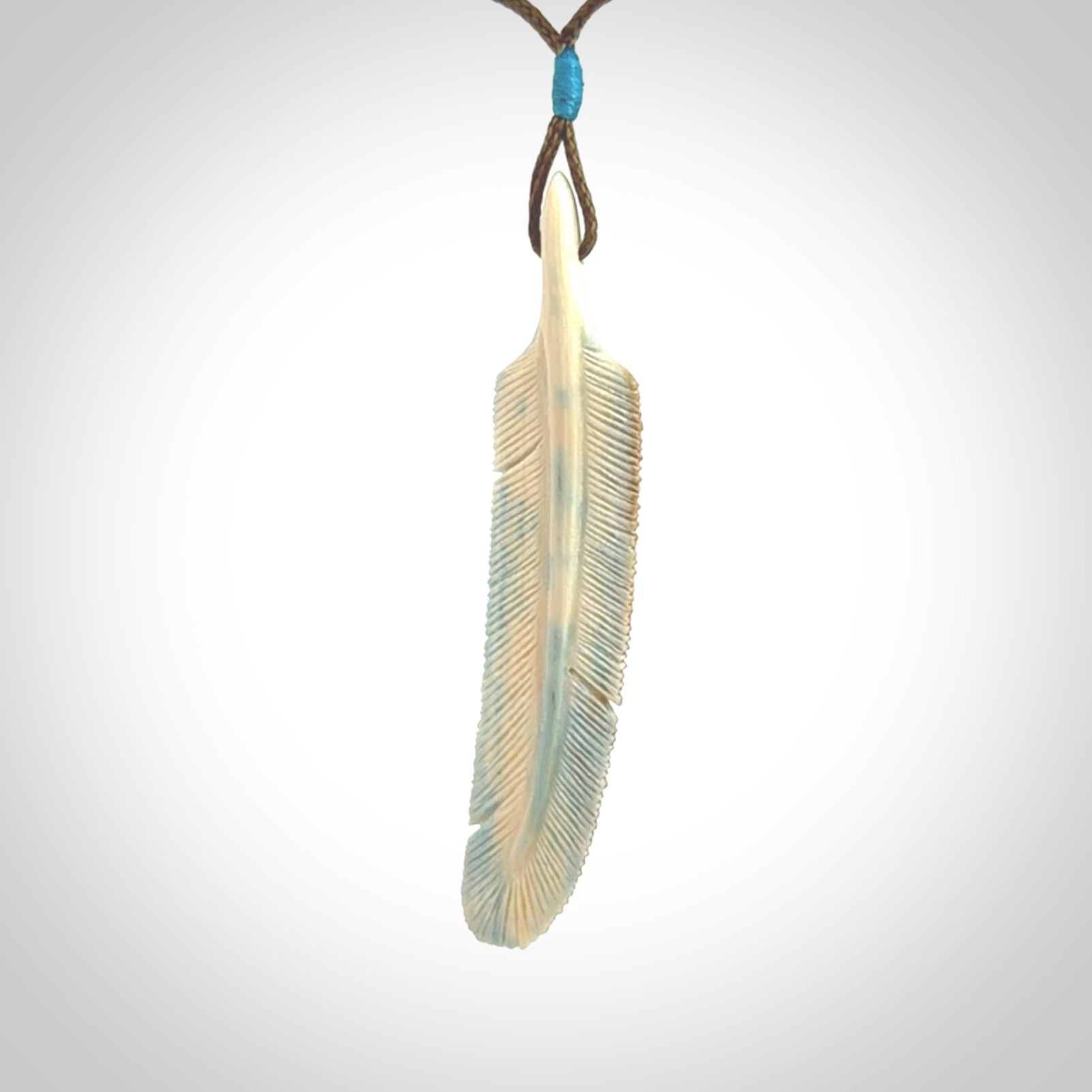 This photo shows a finely carved feather pendant for all you bird lovers and aficionados of the art of flight. It is hand carved by us from rare woolly mammoth tusk.