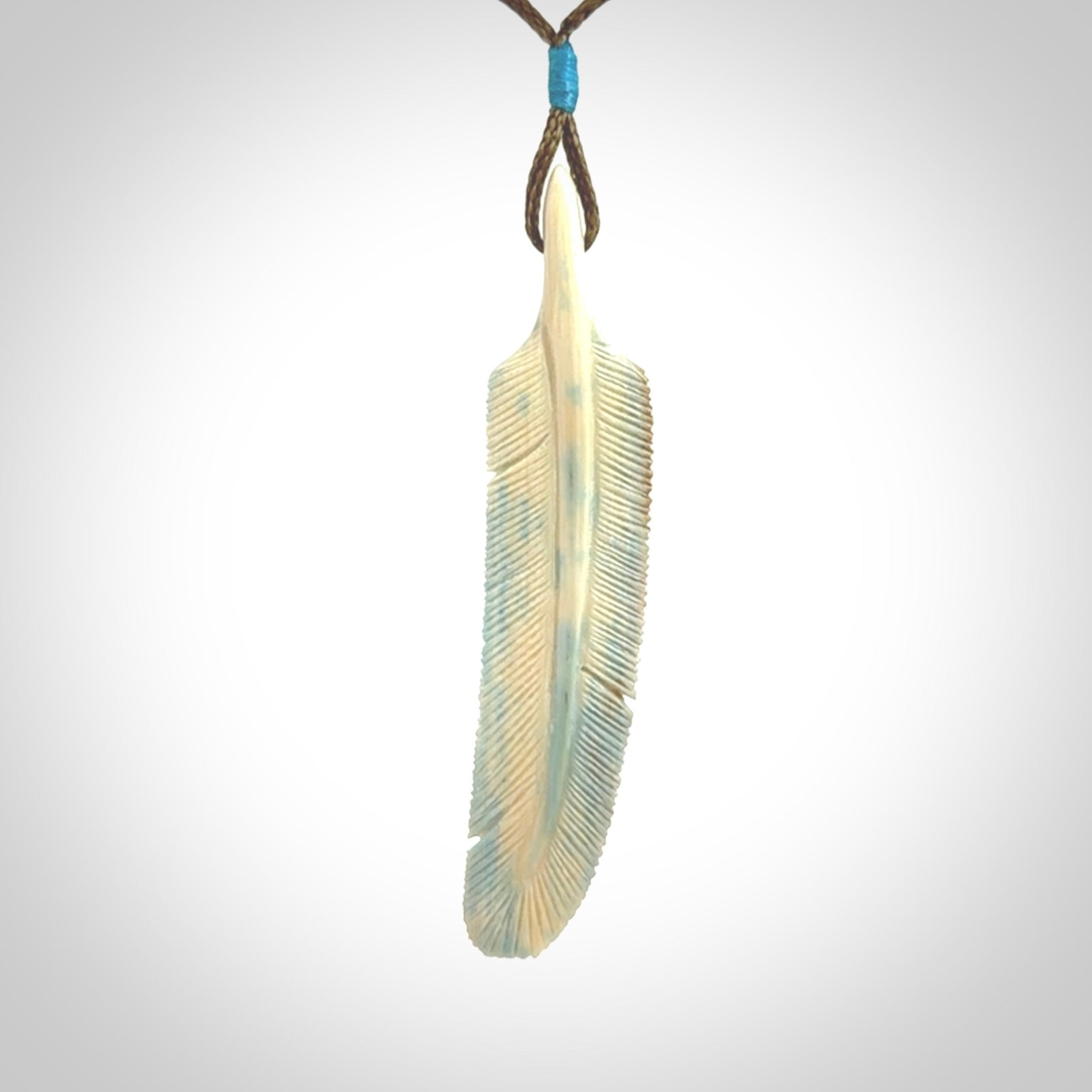 This photo shows a finely carved feather pendant for all you bird lovers and aficionados of the art of flight. It is hand carved by us from rare woolly mammoth tusk.
