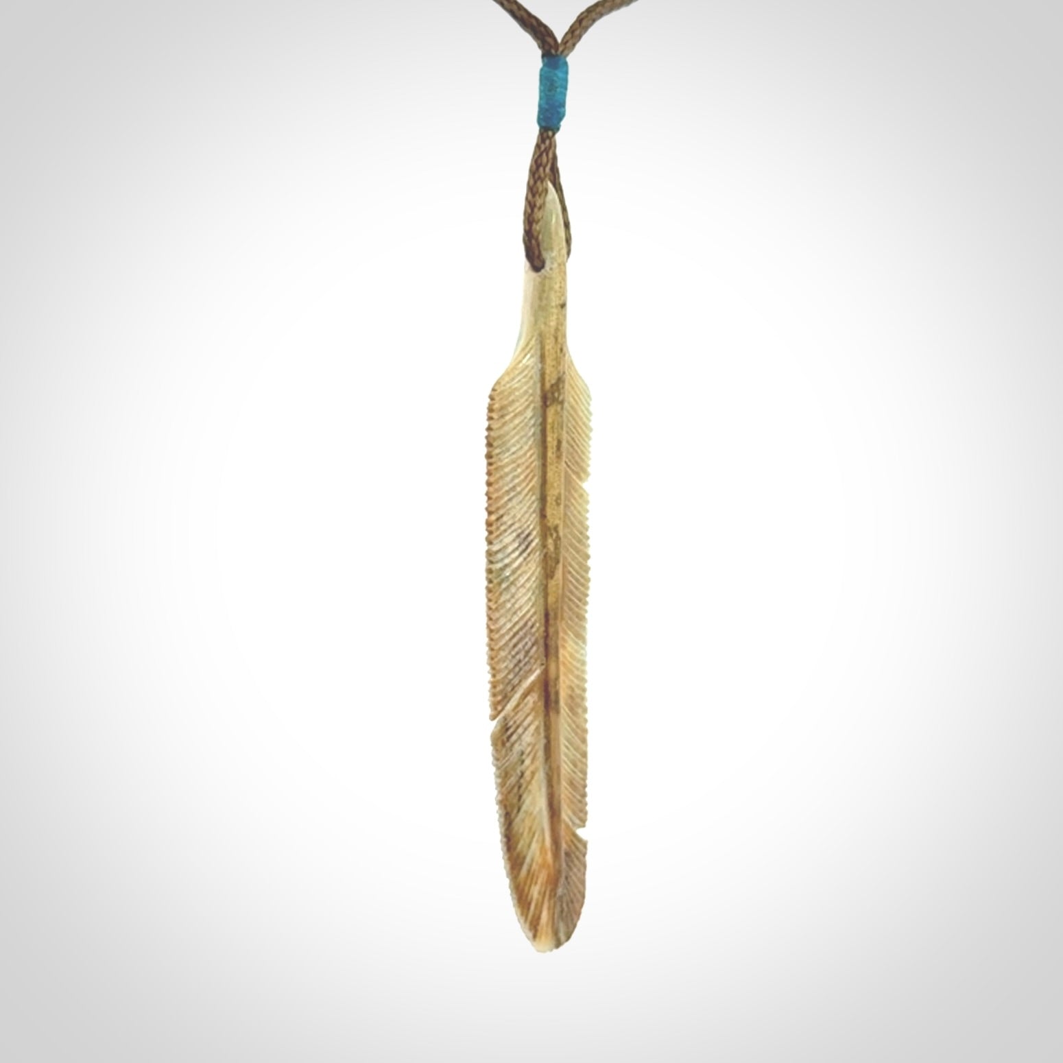 This photo shows a finely carved feather pendant for all you bird lovers and aficionados of the art of flight. It is hand carved by us from rare woolly mammoth tusk.