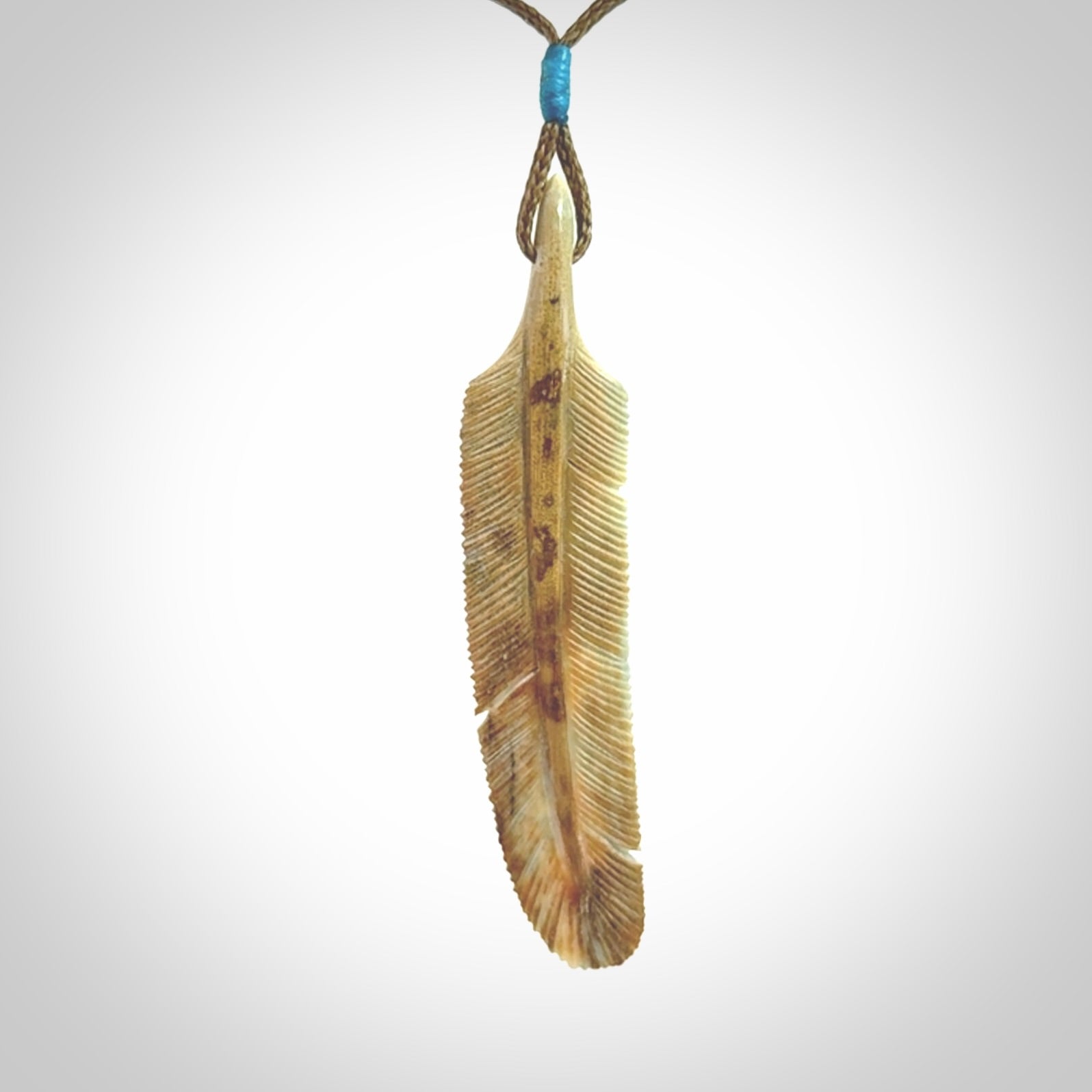 This photo shows a finely carved feather pendant for all you bird lovers and aficionados of the art of flight. It is hand carved by us from rare woolly mammoth tusk.