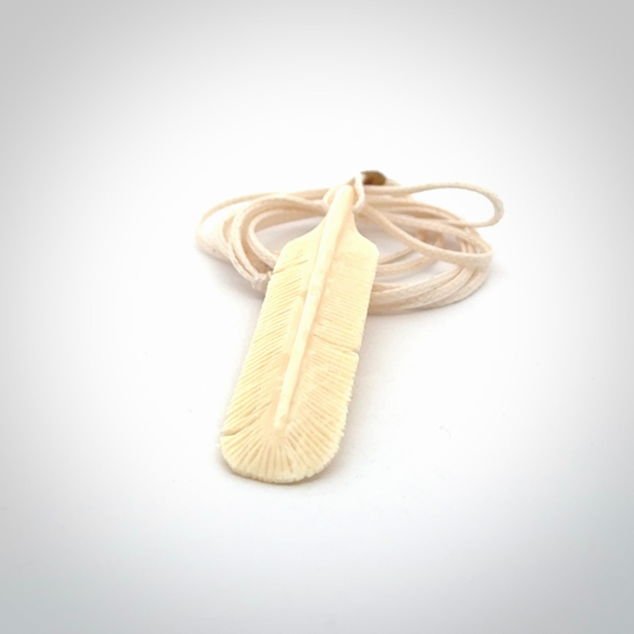 Hand carved Woolly Mammoth Tusk feather pendant. Art to Wear. Provided with adjustable cord.