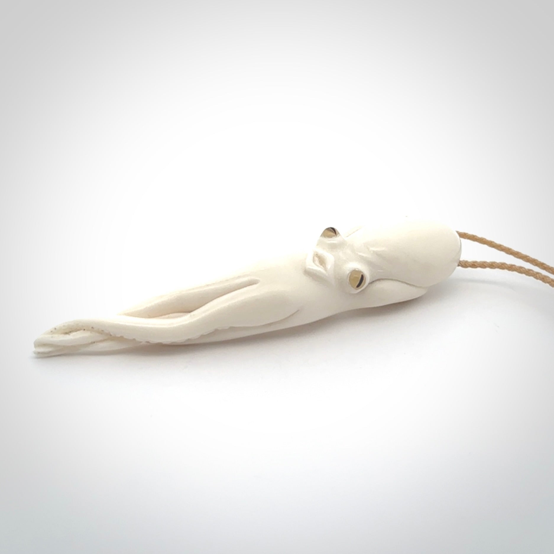 Hand carved octopus pendant in resting pose. This piece has been carved in incredible detail from bone. The artist is Fumio Noguchi, a renowned New Zealand bone carver who carves pieces for NZ Pacific. These unique bone pendants are for sale online at nzpacific.com One only collectors item for lovers of the ocean and octopus.
