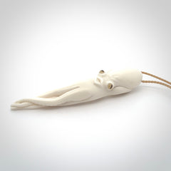 Hand carved octopus pendant in resting pose. This piece has been carved in incredible detail from bone. The artist is Fumio Noguchi, a renowned New Zealand bone carver who carves pieces for NZ Pacific. These unique bone pendants are for sale online at nzpacific.com One only collectors item for lovers of the ocean and octopus.
