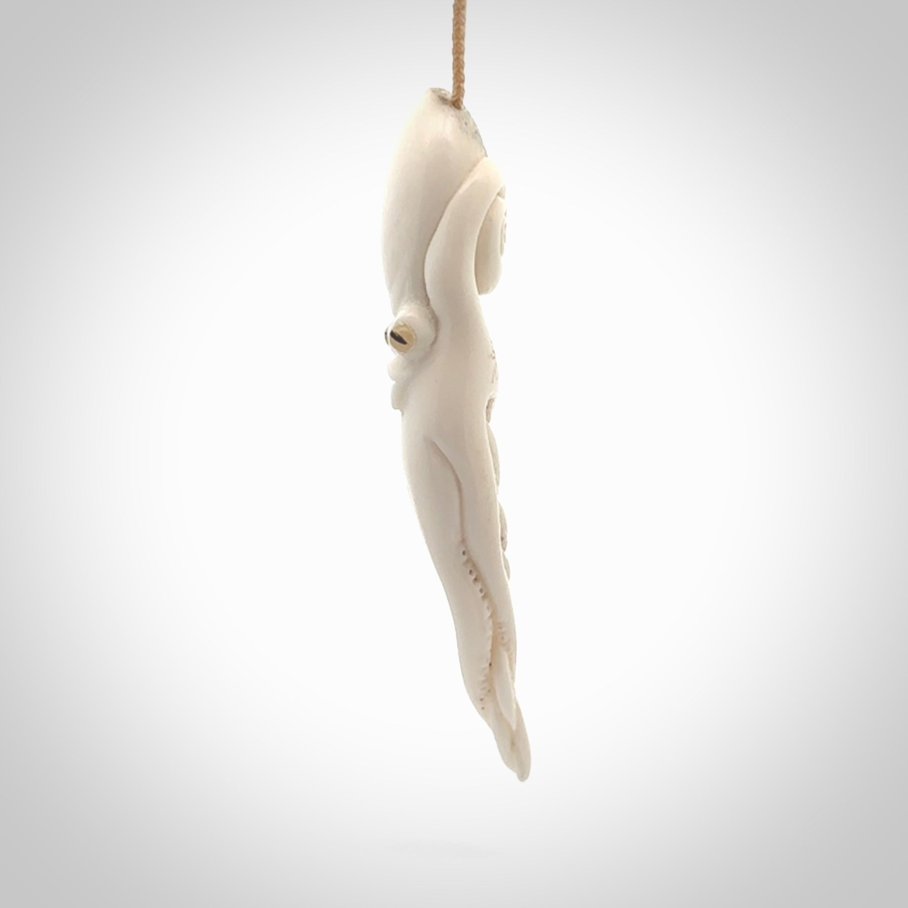Hand carved octopus pendant in resting pose. This piece has been carved in incredible detail from bone. The artist is Fumio Noguchi, a renowned New Zealand bone carver who carves pieces for NZ Pacific. These unique bone pendants are for sale online at nzpacific.com One only collectors item for lovers of the ocean and octopus.