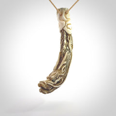 Hand carved dragon Pendant. Made from warthog tusk in New Zealand. Unique dragon necklace hand made from warthog tusk by master bone carver Fumio Noguchi. Spectacular collectable work of art, made to wear. One only pendant, delivered to you at no extra cost with express courier.