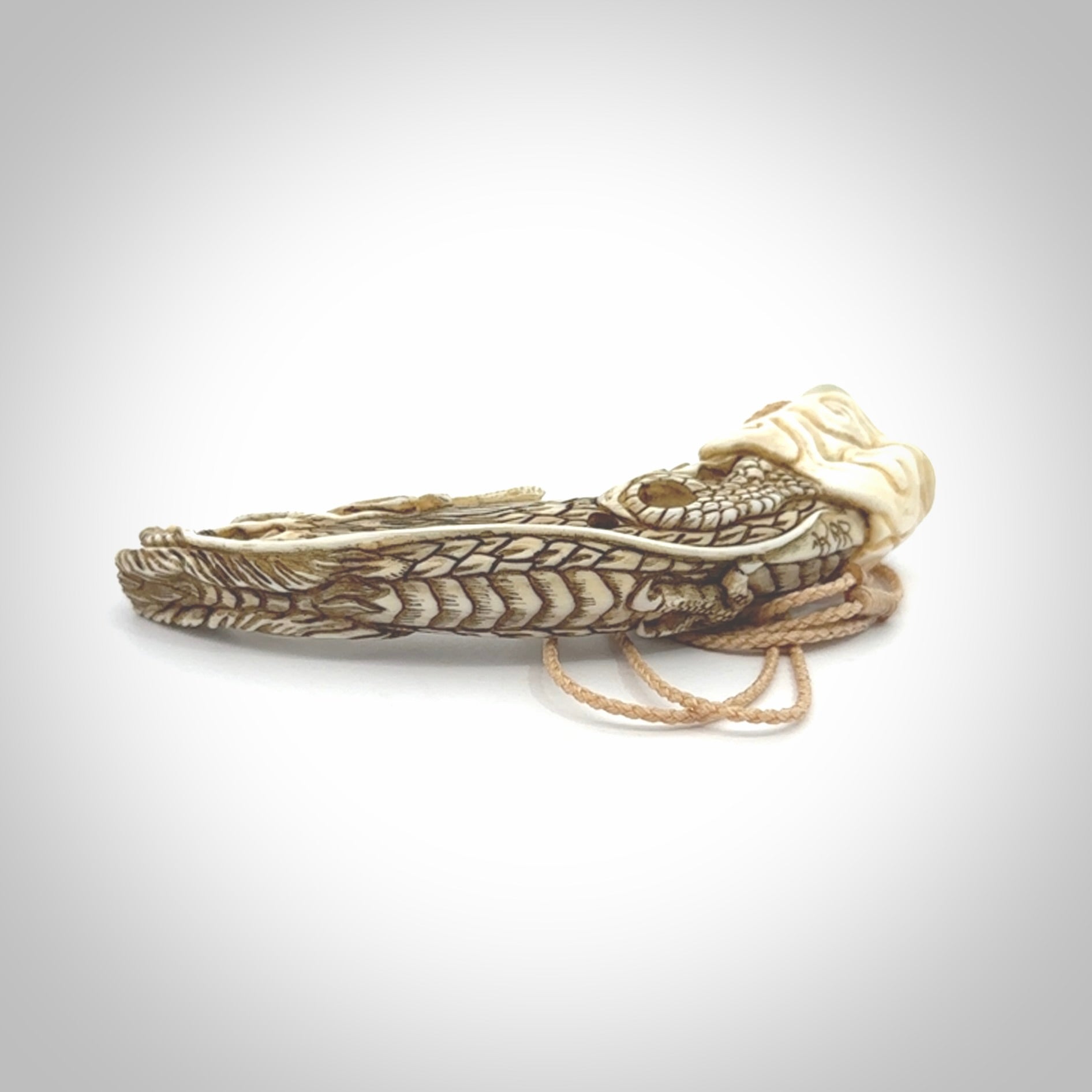 Hand carved dragon Pendant. Made from warthog tusk in New Zealand. Unique dragon necklace hand made from warthog tusk by master bone carver Fumio Noguchi. Spectacular collectable work of art, made to wear. One only pendant, delivered to you at no extra cost with express courier.