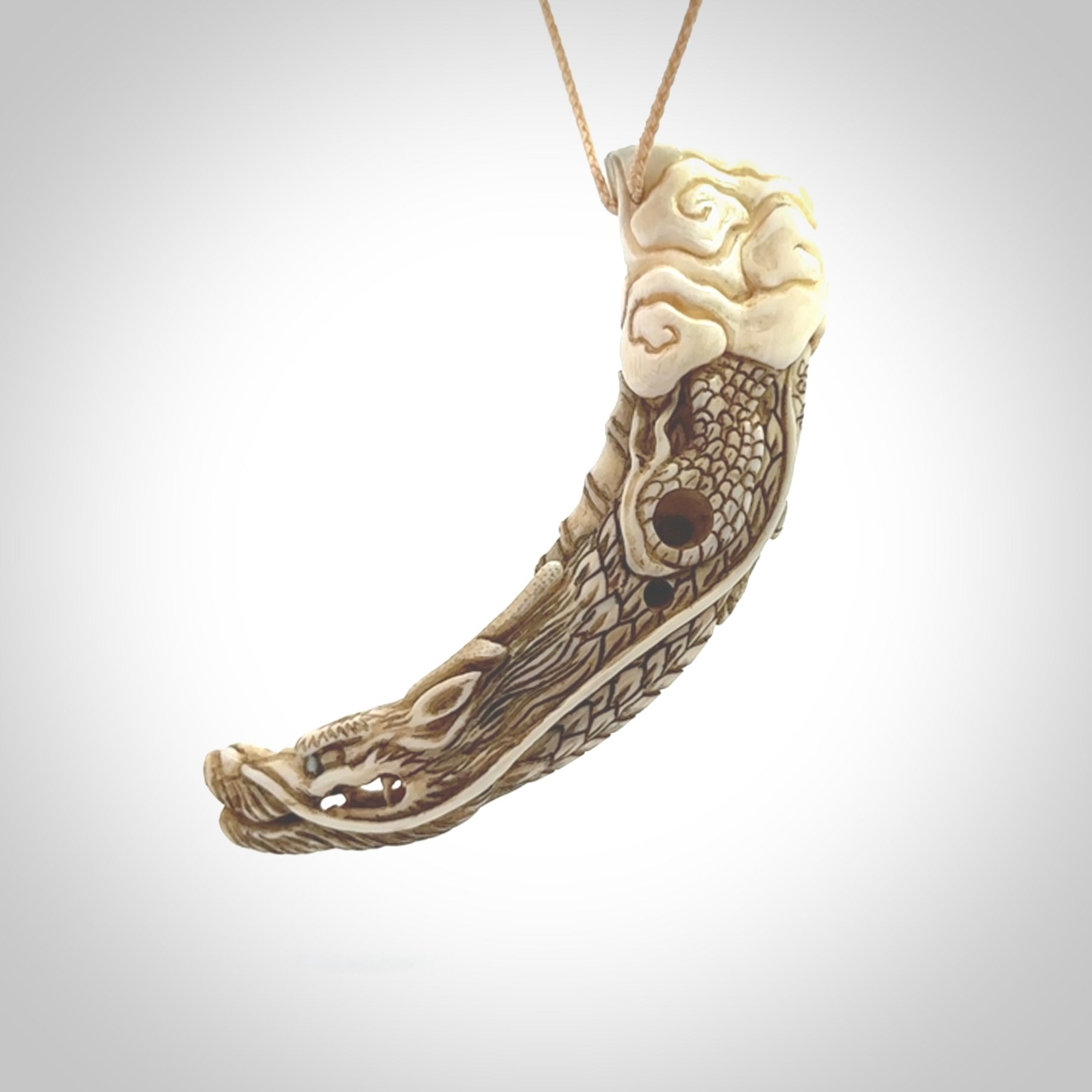 Hand carved dragon Pendant. Made from warthog tusk in New Zealand. Unique dragon necklace hand made from warthog tusk by master bone carver Fumio Noguchi. Spectacular collectable work of art, made to wear. One only pendant, delivered to you at no extra cost with express courier.