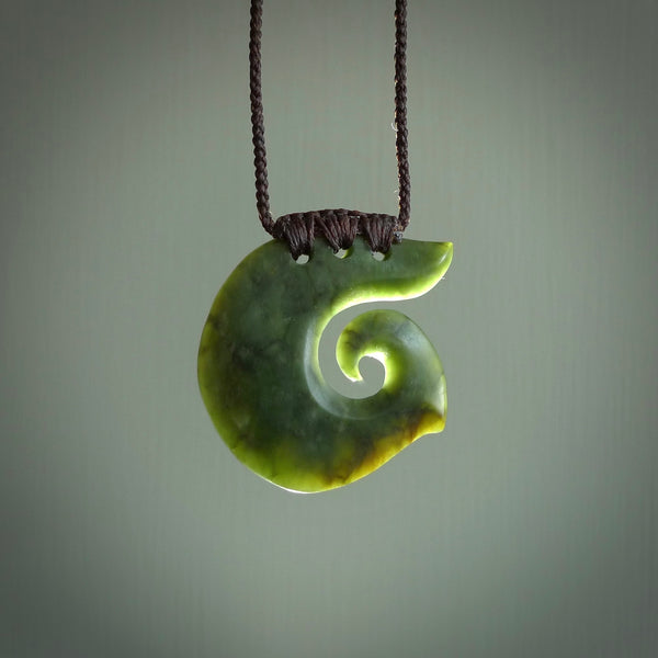 This koru, is carved from a very striking New Zealand jade. It is both intricate and simple in design - it has hidden folds and smooth curves. A piece to be worn or displayed - the carving and the jade are both magnificent.