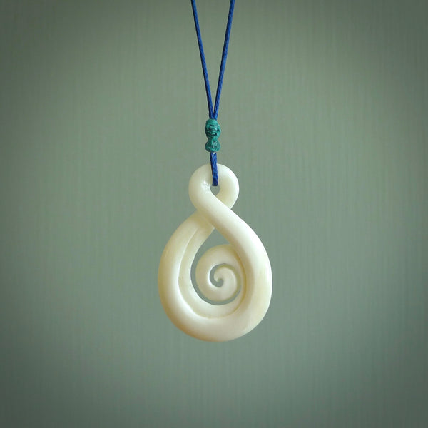 Hand carved bone twist with koru pendant. Real natural bone. These are suspended on a length adjustable plaited cord.