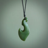 This contemporary hook, is carved from a very striking New Zealand jade. It is both intricate and simple in design - it has hidden folds and smooth curves. A piece to be worn or displayed - the carving and the jade are both magnificent.