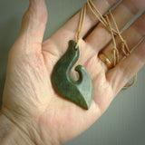 This matau, is a large pendant hand carved from New Zealand jade. It is both intricate and contemporary in design - it has hidden folds and smooth curves. A piece to be worn, the carving and the jade are both magnificent. A large hand carved New Zealand Jade hook by artist Ric Moor.