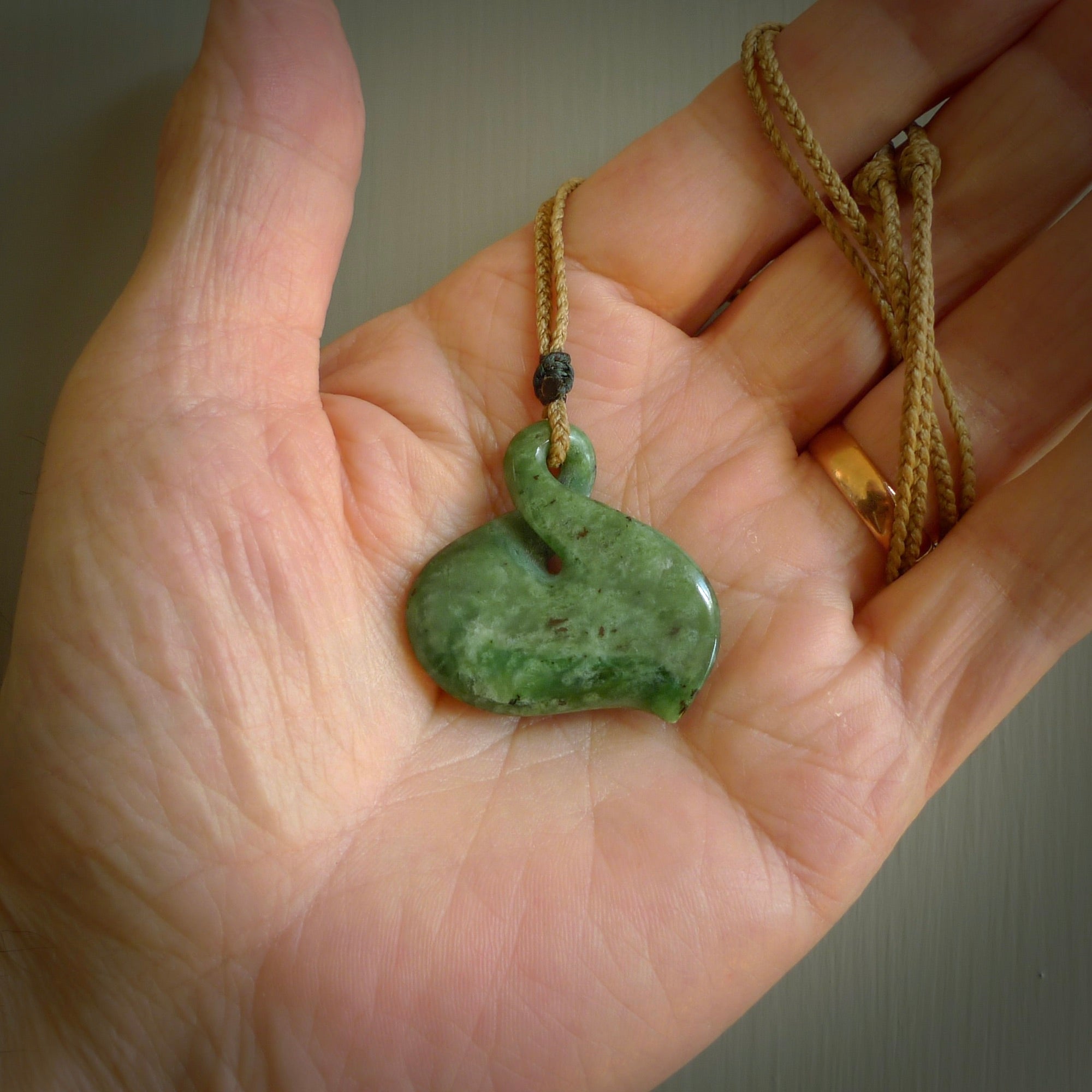 Hand carved New Zealand jade, single twist pendant. Maori pikorua pendant hand carved in New Zealand. Made by NZ Pacific, jade jewellery for sale online. One only hand made by Ross Crump.